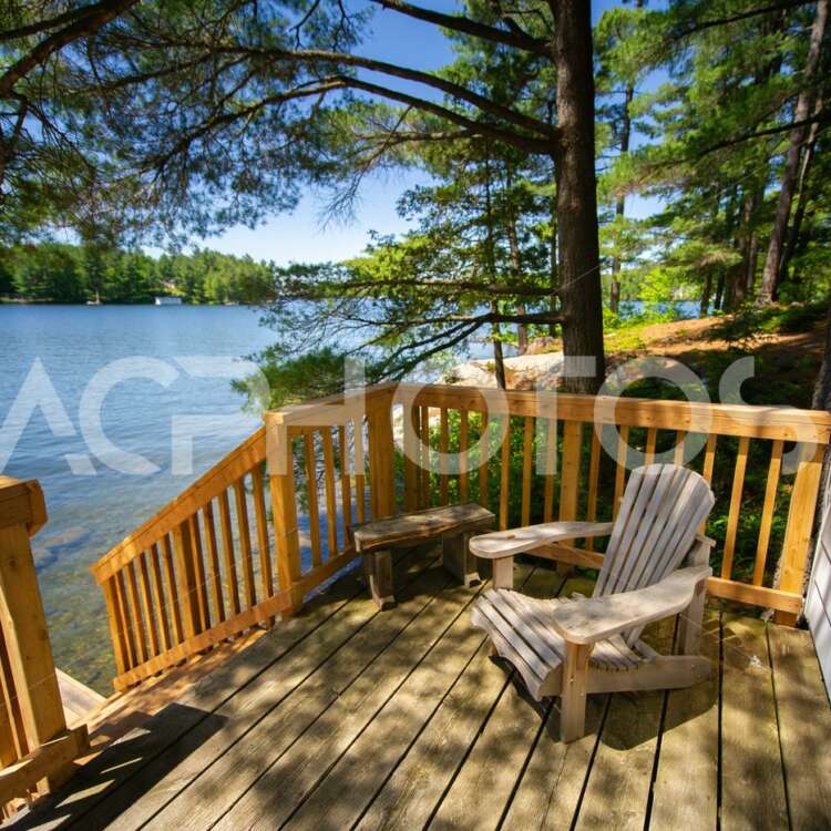 Adirondack chair sitting on a cottage wooden deck 2850