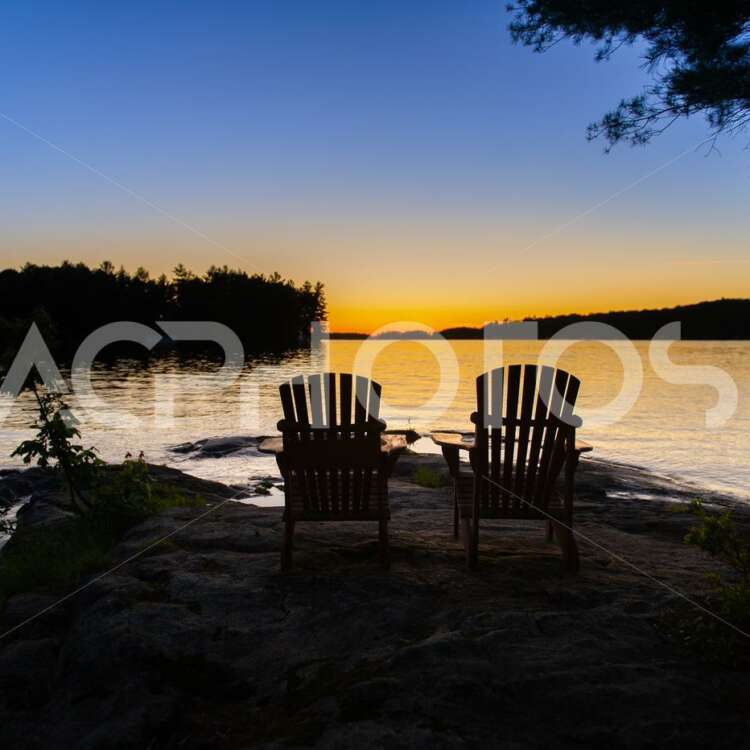 Adirondack chairs facing water 2868