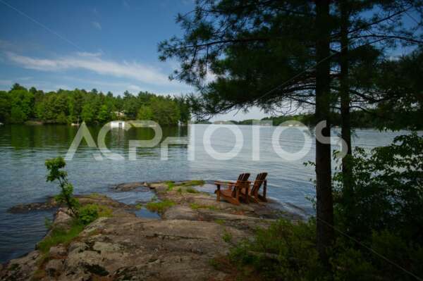 Adirondack chairs near the water 2702