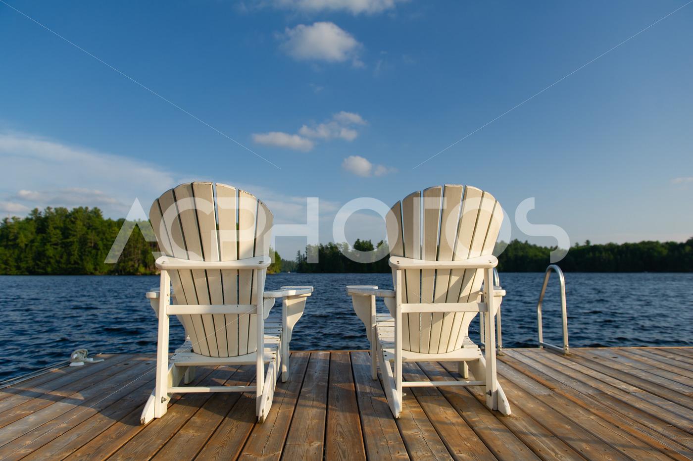 Adirondack chairs on a wooden dock 2576