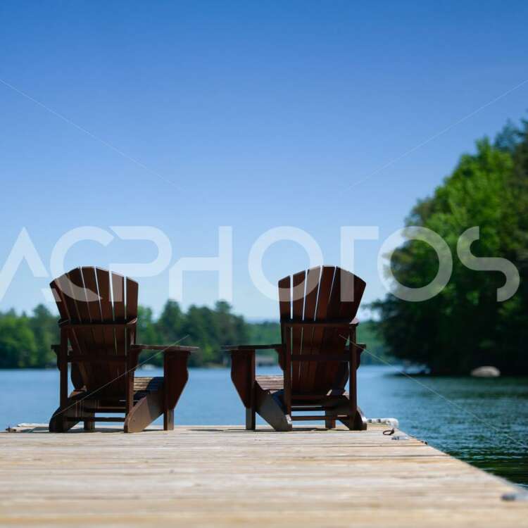 Adirondack chairs on a wooden dock 2742