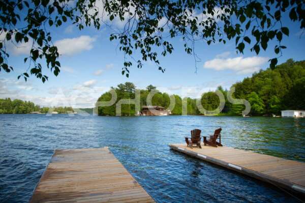 Adirondack chairs on a wooden dock 2838
