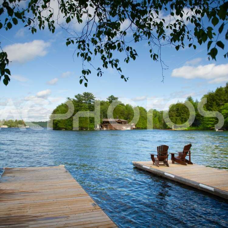 Adirondack chairs on a wooden dock 2838