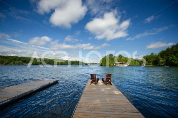 Adirondack chairs on a wooden dock 2844