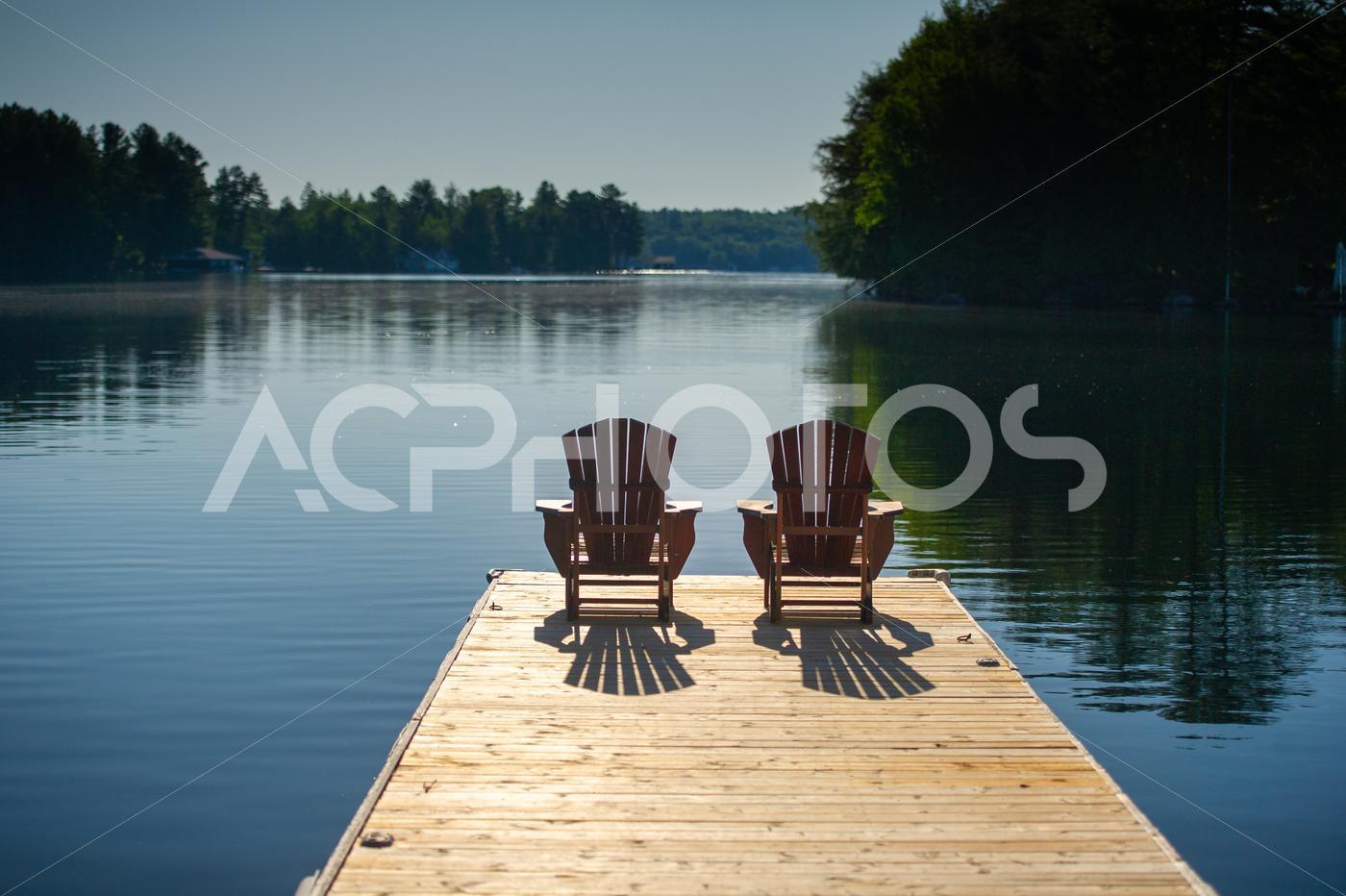 Adirondack chairs on a wooden dock 2910