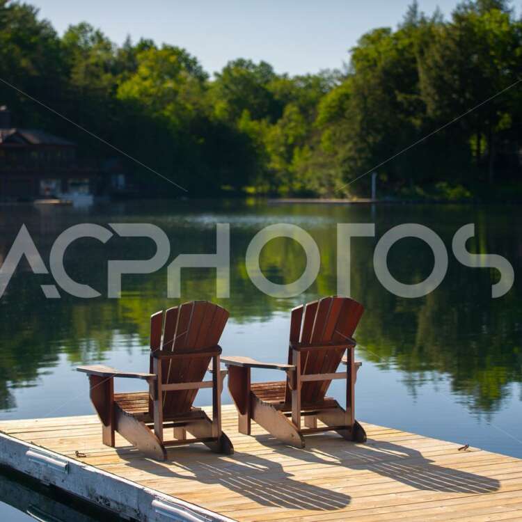 Adirondack chairs on a wooden dock 2934