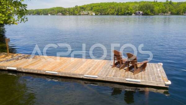 Adirondack chairs on a wooden dock 2988