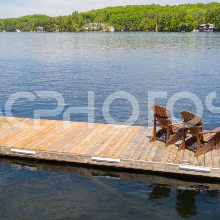 Adirondack chairs on a wooden dock 2988