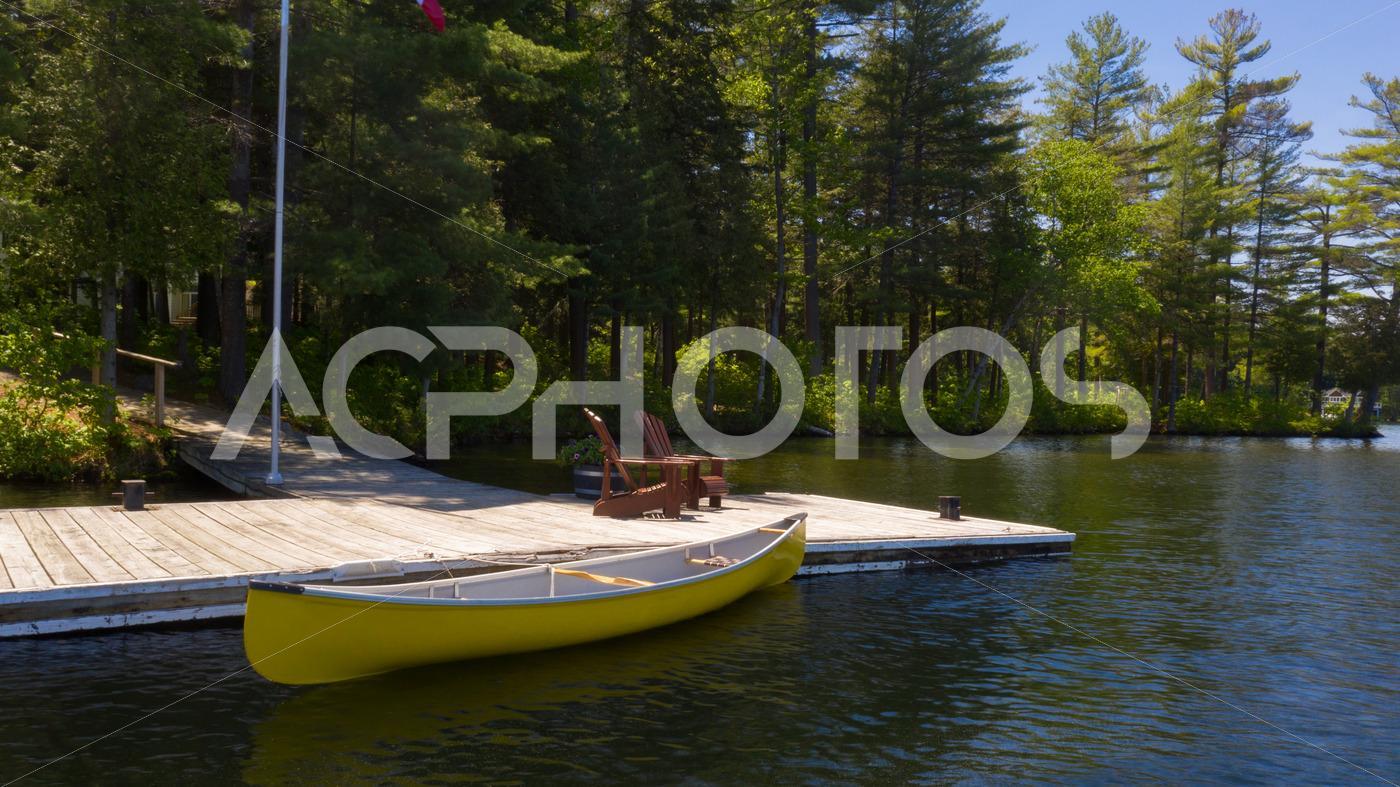 Adirondack chairs on a wooden dock 3000