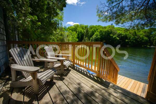 Adirondack chairs sitting on a cottage wooden deck 2856