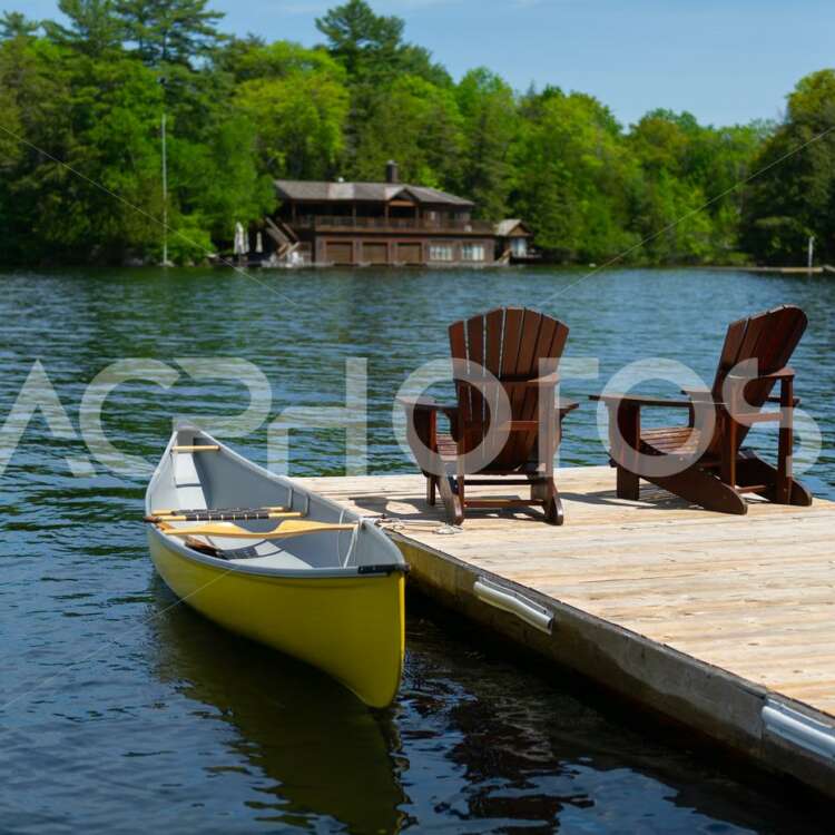 Adirondack chairs with a yellow canoe 2766