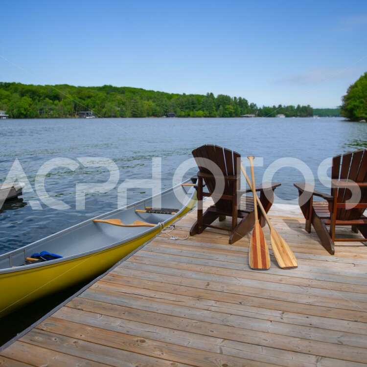 Adirondack chairs with a yellow canoe 2814
