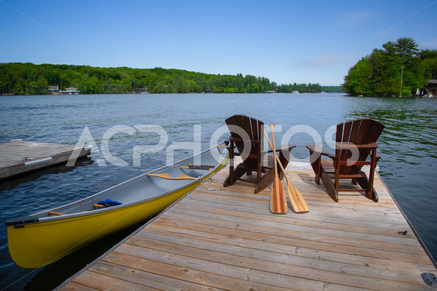 Adirondack chairs with a yellow canoe 2814