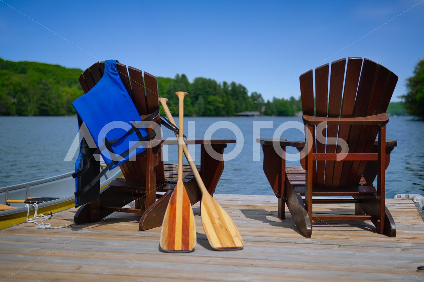 Adirondack chairs with canoe paddles and life jacket 2802