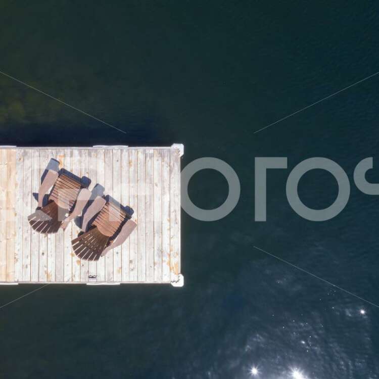Aerial view of Two Adirondack chairs on a wooden dock - Alessandro Cancian Photography