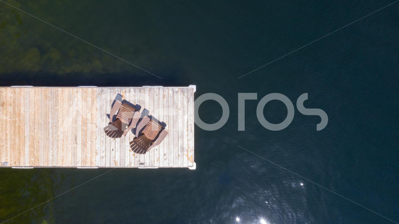 Aerial view of Two Adirondack chairs on a wooden dock 2976