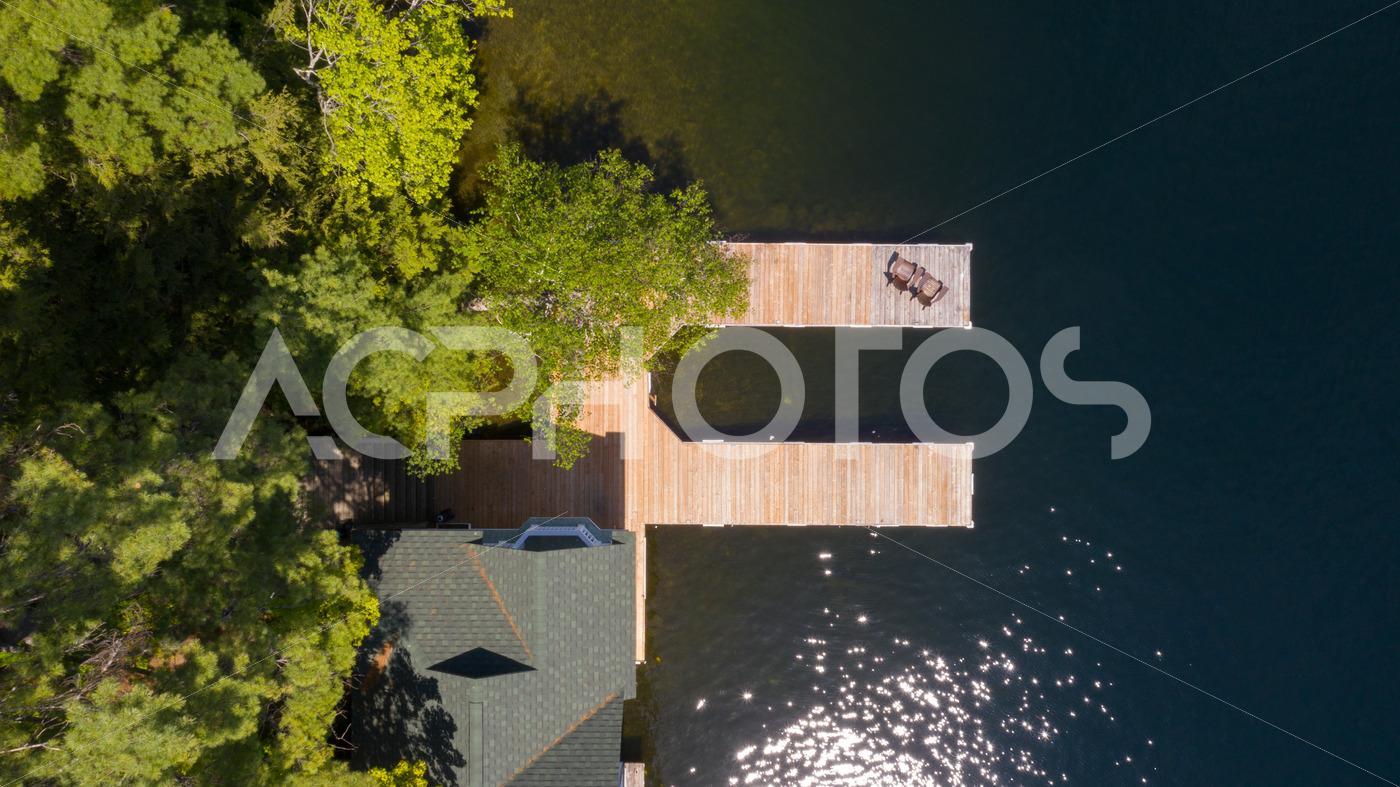 Aerial view of two Adirondack chairs on a wooden dock 2982