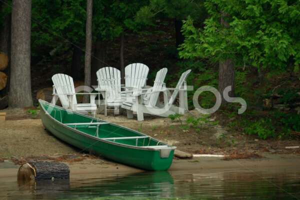 Green canoe on a sandy shore 2624