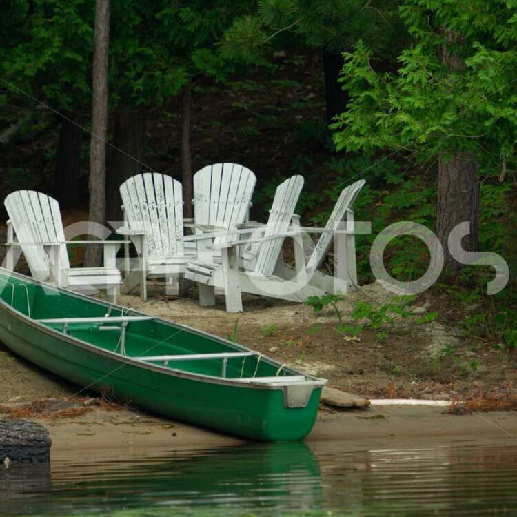Green canoe on a sandy shore 2624