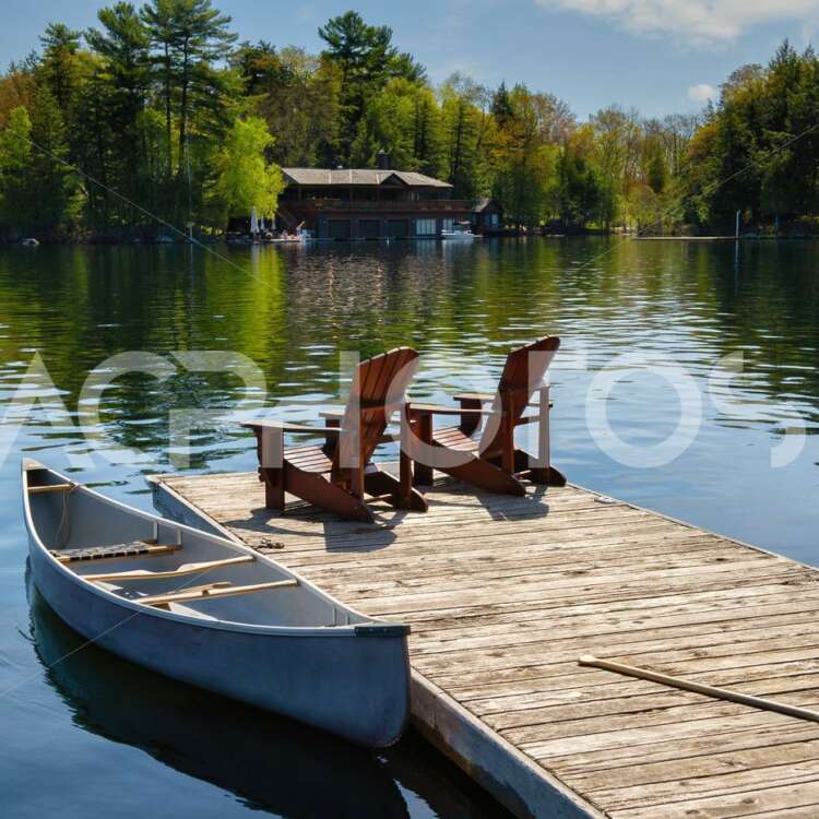 Muskoka chairs sitting on a dock 2964