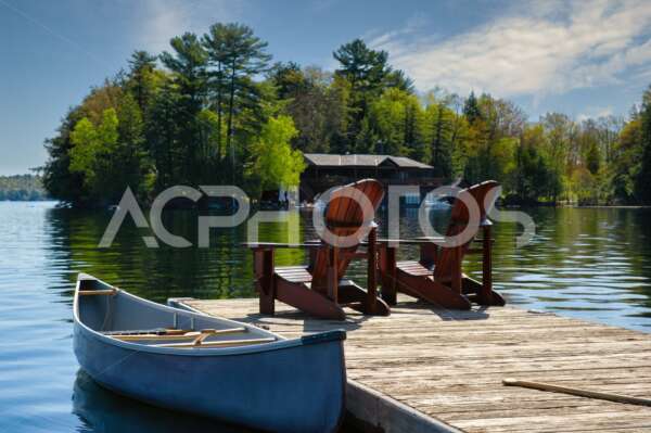 Muskoka chairs sitting on a wood dock - Alessandro Cancian Photography