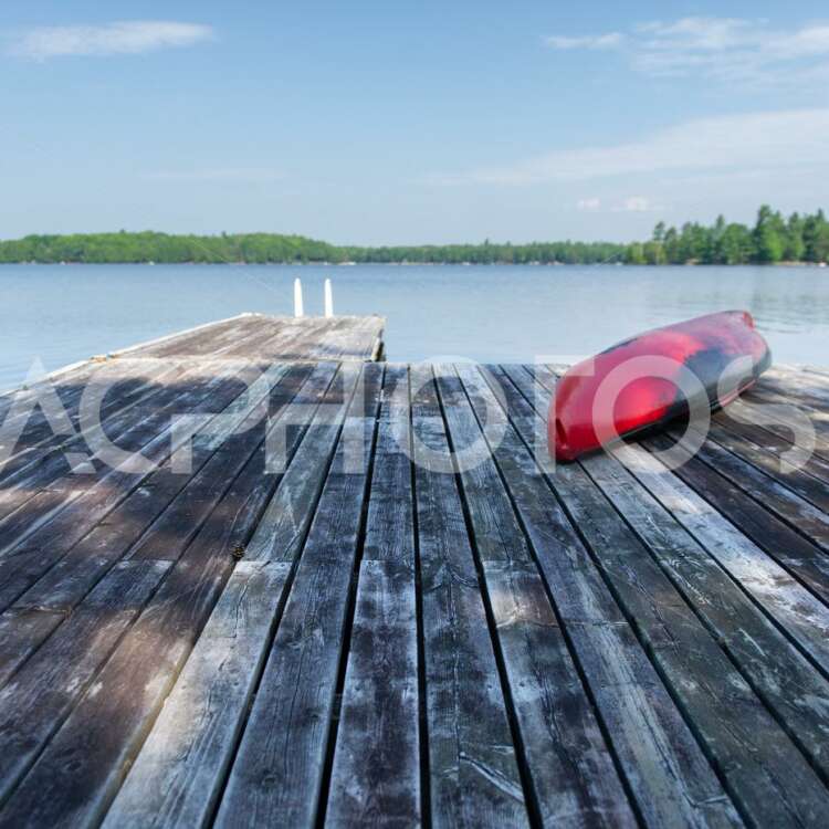 Red kayak rest on a lake wooden pier - Alessandro Cancian Photography
