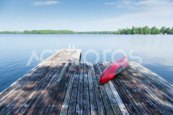 Red kayak rest on a lake wooden pier 2546