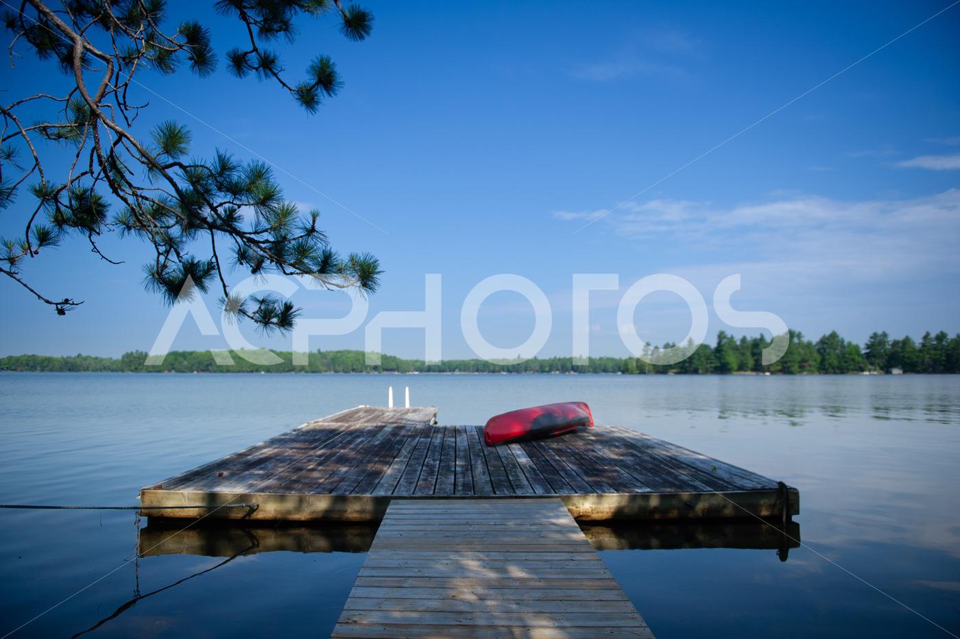 Red kayak sitting on a lake wooden pier 2522