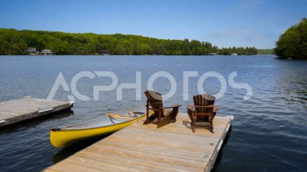 Two Adirondack chairs and a yellow canoe 3011