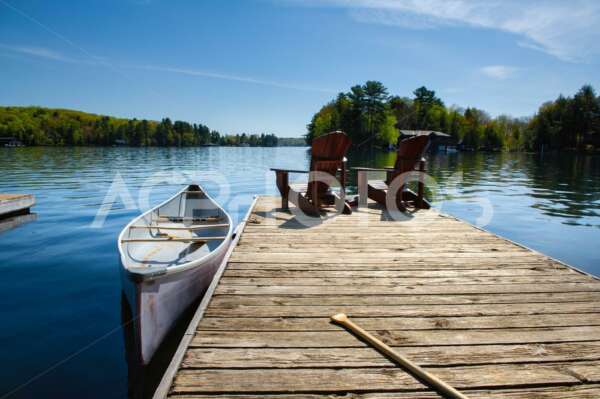 Two Adirondack chairs sitting on a wood dock - Alessandro Cancian Photography
