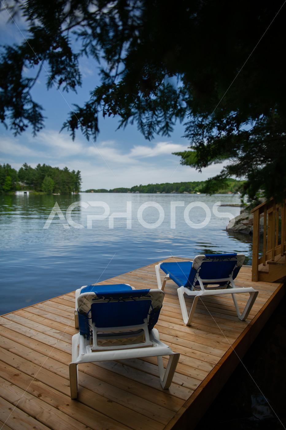 Two sunbeds on a cottage wooden dock 2684