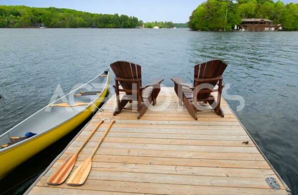 Yellow canoe and Adirondack chairs 2832