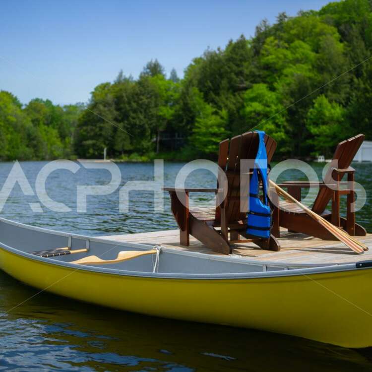 Yellow canoe tied to cottage dock 2790