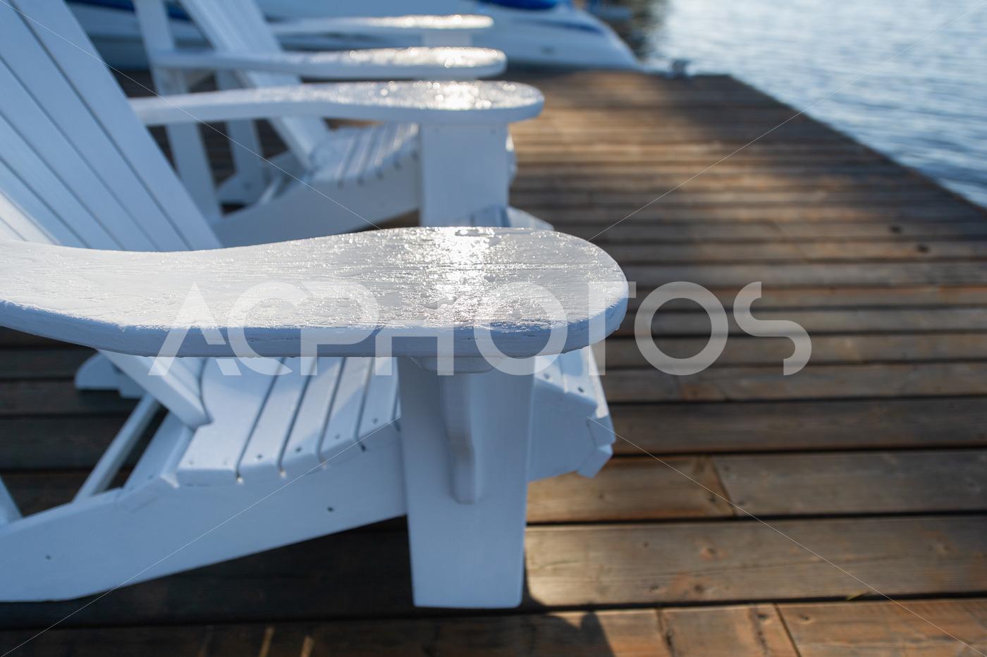 Close up on two White Adirondack chairs 3462