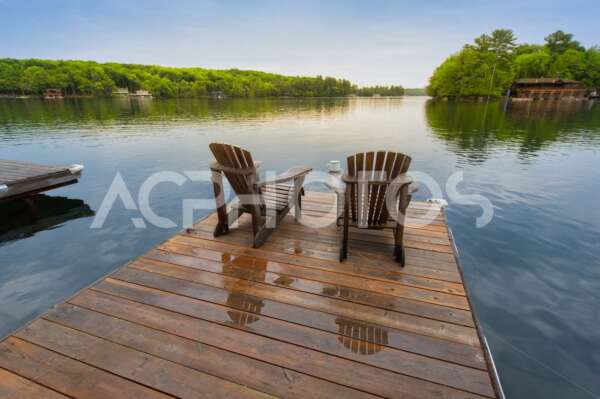 Muskoka chairs on a wet dock 3242