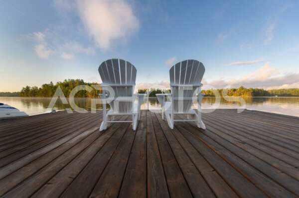 Two White Adirondack chairs in Muskoka - GettaPix