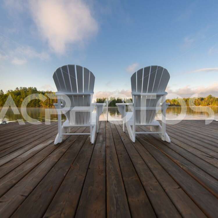 Two White Adirondack chairs in Muskoka - GettaPix