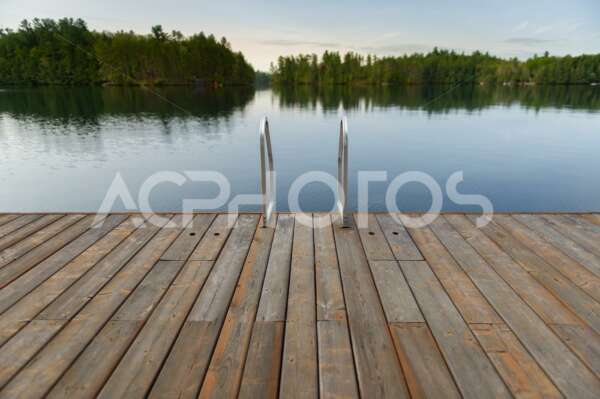 Wooden dock floating on a calm lake 3528