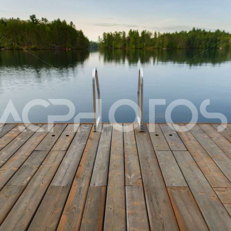 Wooden dock floating on a calm lake 3528