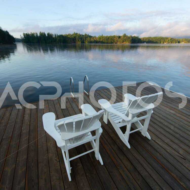 White Adirondack Chairs Facing Lake - GettaPix
