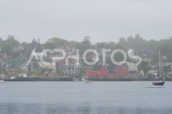 Foggy view of the harbor front of Lunenburg, Nova Scotia - GettaPix