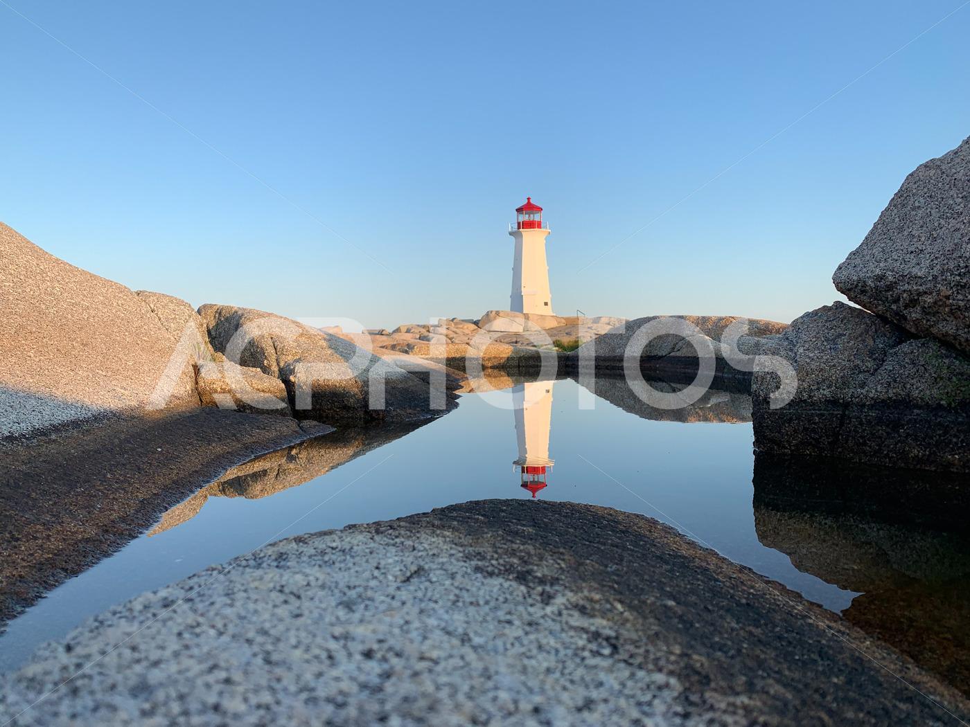 Peggy’s Cove Lighthouse reflecting on the water - GettaPix