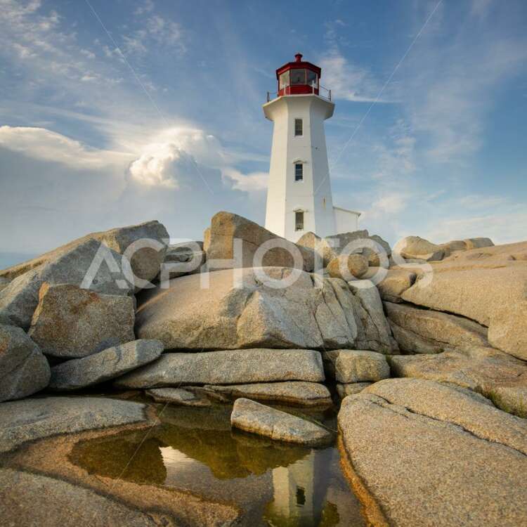Peggy’s Cove lighthouse at mirroring on a water puddle - GettaPix
