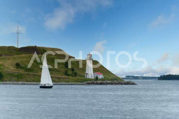 Sail boat circling Georges Island on Halifax harbour - GettaPix