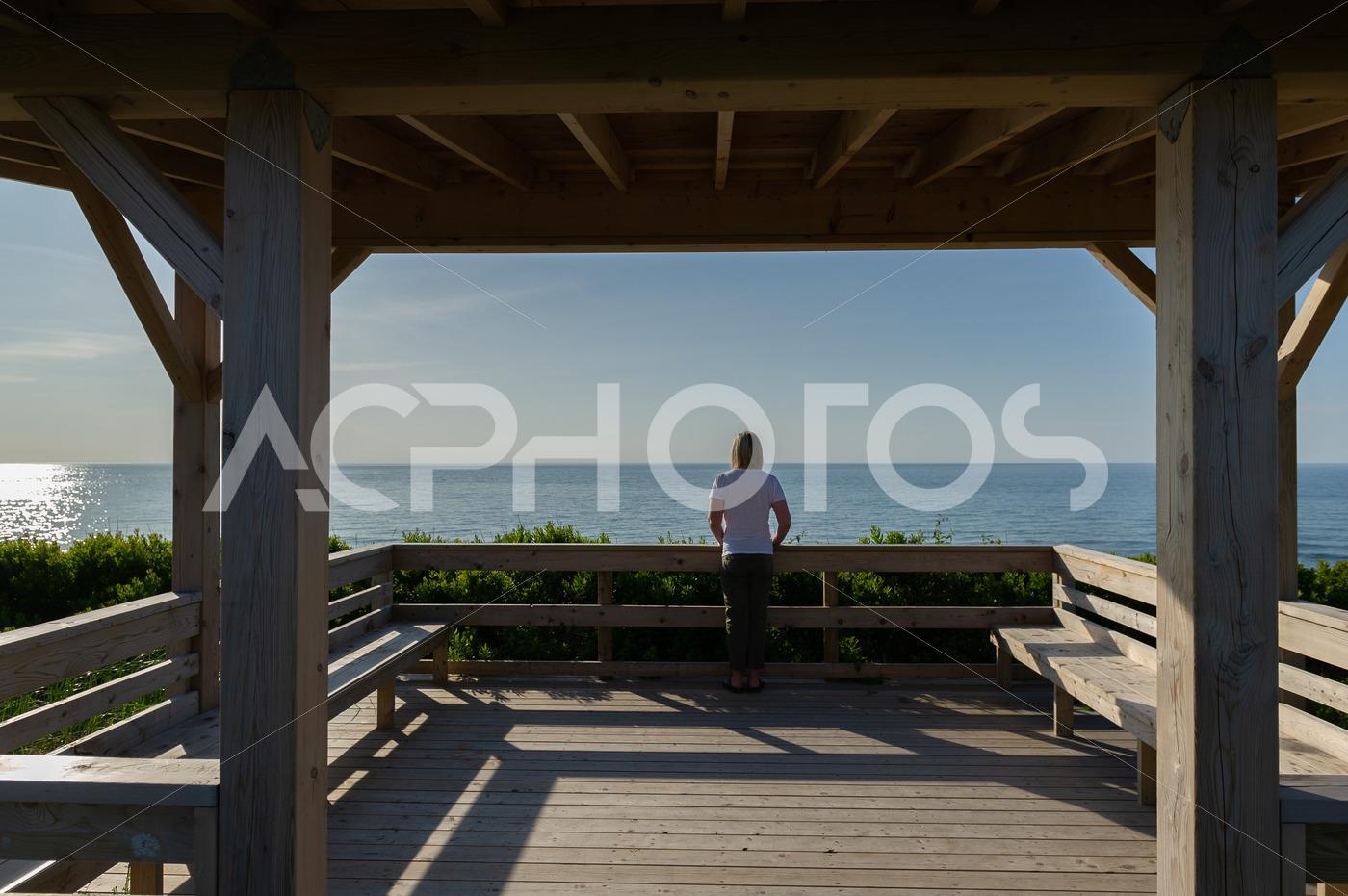Young woman looking at the ocean from the lookout of the beach in Inverness - GettaPix