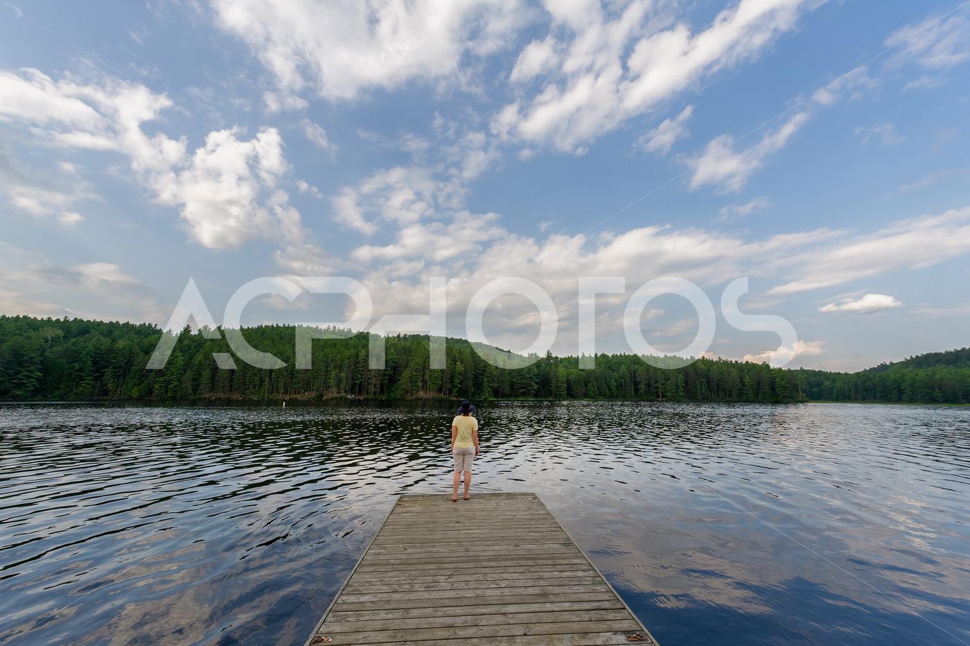 A young woman is captivated by the beauty of Algonquin Provincial Park - GettaPix