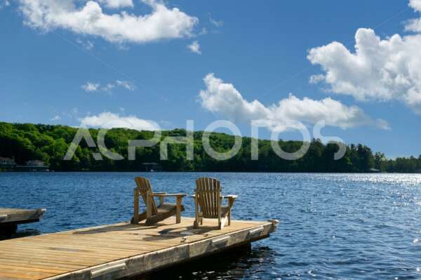 Adirondack chairs on a wooden dock in Muskoka - GettaPix