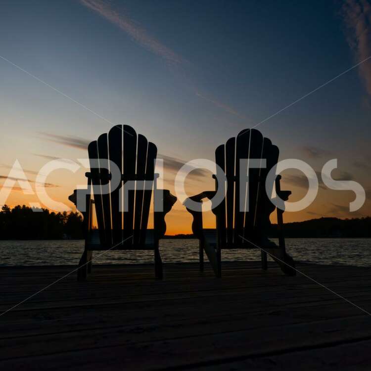 Adirondack chairs on a wooden dock in Muskoka - GettaPix