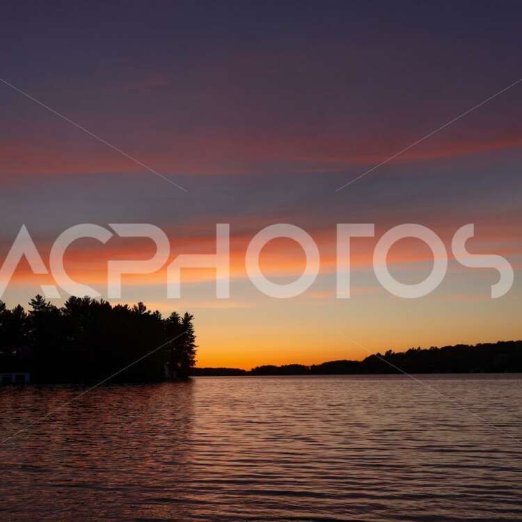Beautiful sunset on a calm lake in Muskoka - GettaPix