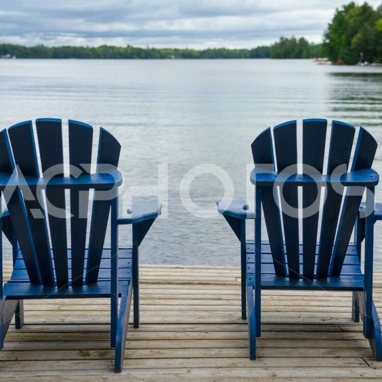 Close up of two blue Adirondack chairs - GettaPix